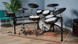 Alesis Strata Prime electronic drum set in a blue room