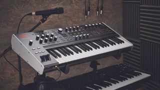 An ASM Hydrasynth on a stand in a recording studio